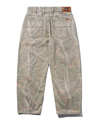 Back view of camouflage pants with a woodland tree-bark pattern in muted green, brown, and beige tones, featuring a brown leather patch on the back waistband.